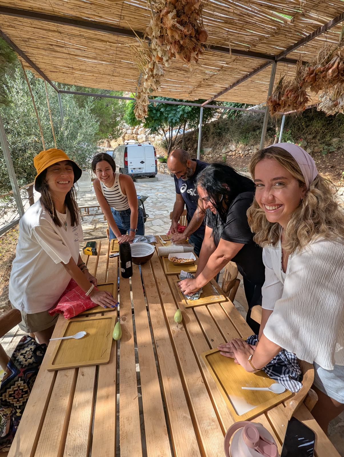 Visitors gathered around a wooden farm table for a workshop