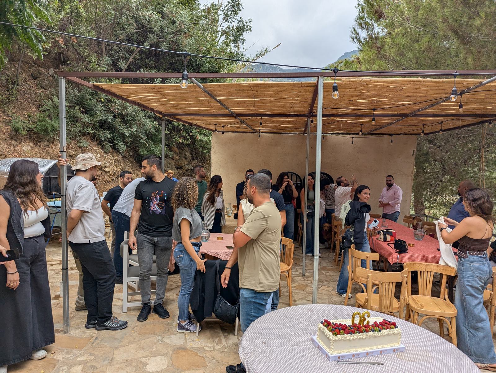 A gathering under a shaded farm terrace